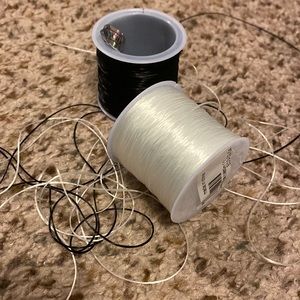 Two spools of stretchy band for bracelet making